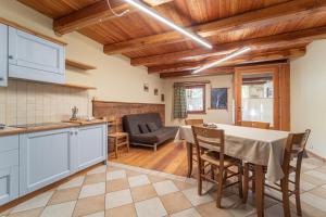 a kitchen and dining room with a table and chairs at Civico 7 in Marmora