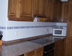 a kitchen with wooden cabinets and a counter top at Casa Rural Barbonea in Lekunberri