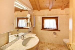 a bathroom with a sink and a tub and a toilet at Appartamento Jolly in Livigno +16 photos