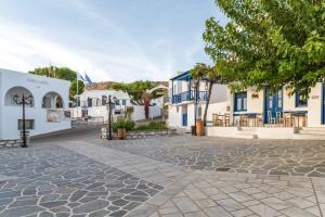 a cobblestone street in a town with white buildings at Lithos in Kóstos