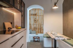 a kitchen with a table and a shower at Lithos in Kóstos
