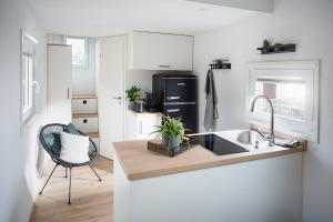 a kitchen with a sink and a counter top at Tiny Om Ferienhaus in Laichingen +17 photos