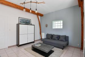 a living room with a couch and a coffee table at Domaine De L'olympe in Domart-en-Ponthieu +14 photos