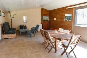 a dining room with a table and chairs at Domaine De L'olympe in Domart-en-Ponthieu