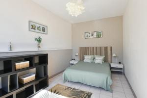 a bedroom with a bed and two night stands at Domaine De L'olympe in Domart-en-Ponthieu