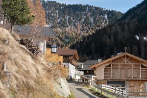 a mountain village with houses on a road at Apt Bergblick Hinterproslhof in Sarntal