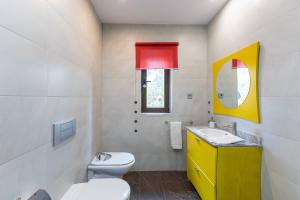 a bathroom with a toilet and a sink and a mirror at El Herrén Del Abuelo in Vegas de Matute +27 photos