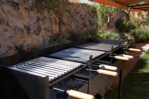 a bbq grill with two rolls at El Herrén Del Abuelo in Vegas de Matute