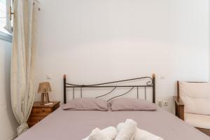a bed with two pillows on it in a bedroom at Anastasias Studios Mykonos in Plintri