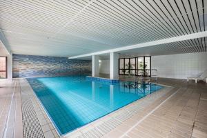 a large swimming pool in a building at Apartement Bublitz in Travemünde +22 photos