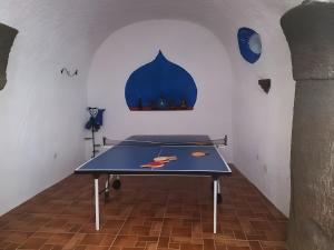 a ping pong table in the middle of a room at Los Jazmines in Benalúa de Guadix