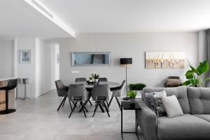 a living room with a couch and a table at Penthouse Apt With Ocean View in Estepona