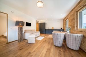 a living room with a table and a couch at Naturapartments Alpreid Altholz in San Pancrazio dʼUltimo