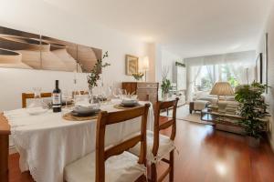 a dining room with a table with a white table cloth at Canet Platja Apartment in Canet de Mar