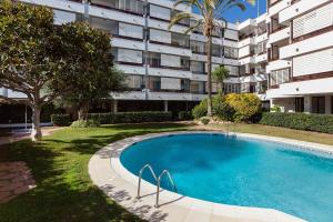 a swimming pool in front of a apartment building at Canet Platja Apartment in Canet de Mar