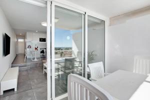 a dining room and living room with a table and chairs at Tamaran Bureba 511 in Maspalomas