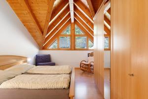 a bedroom with a bed and a large window at Melcherhof in Trodena