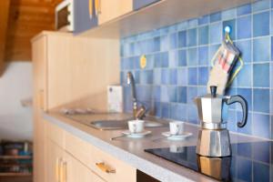 a kitchen counter with a coffee maker and cups on it at Melcherhof in Trodena +45 photos