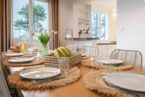 a table with plates and bowls of food on it at Lividig Bleue en face de la mer in Brignogan-Plage