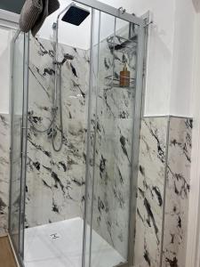 a shower with a glass door in a bathroom at Al Vicolo in Intra +34 photos