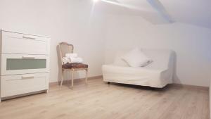 a living room with a chair and a dresser at Studio charmant avec jardin in Saint-Rémy-de-Provence
