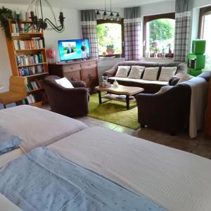 a living room with a couch and a tv at Eifelstube Langerwehe in Langerwehe