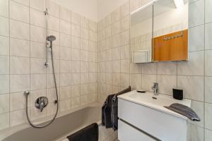a bathroom with a shower and a sink and a tub at Naturnahe Ferienwohnung Deuerling in Deuerling +13 photos