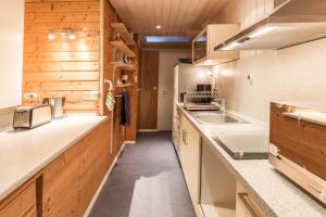 a kitchen with wooden walls and counters and a sink at Ferienwohnung Faden in Konstanz
