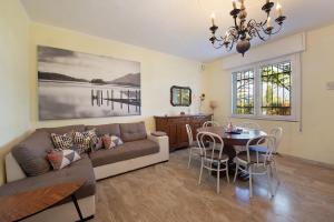 a living room with a couch and a table at Villa Iconi Lake Garda in Manerba del Garda