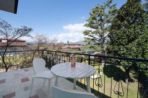 a table and chairs on a balcony with a view at Villa Iconi Lake Garda in Manerba del Garda