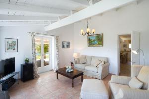 a living room with a couch and a table at Old Olive Press Sea and Mountain in Ágios Márkos