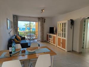 a living room with a table and a couch at casa agua y sol 2 in Poris de Abona