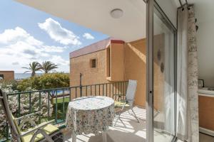 a balcony with a table and a view of the ocean at casa agua y sol 2 in Poris de Abona