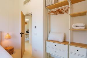a bedroom with a bunk bed and a closet at Casa La Petite in San Pantaleo