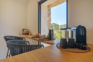 a kitchen with a table with a coffee maker on it at Casa La Petite in San Pantaleo