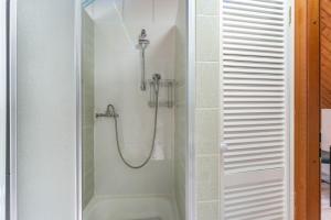 a bathroom with a shower with a glass door at Ferienwohnung Ostseeclick in Damp +20 photos