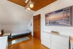a room with a bed and a large picture on the wall at Ferienwohnung Ostseeclick in Damp