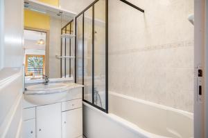 a bathroom with a sink and a shower and a tub at Gite Palombe in Lanvallay +15 photos