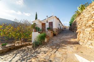 a street in a village with a building at C´antonia Y Manuel in Laroya
