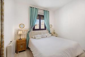 a bedroom with a white bed and a window at Casa Dos Mares in Cádiz +25 photos