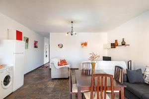 a kitchen and living room with a table and a dining room at Chalet Rocío - solo familias in Conil de la Frontera