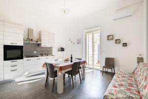 a kitchen and dining room with a table and chairs at Casa Vacanze Lu Rizzaru in Nardò +17 photos