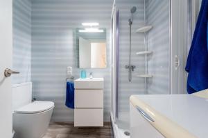 a bathroom with a shower and a toilet and a sink at Vora Port in L'Ampolla +12 photos