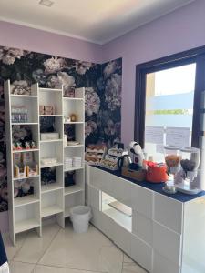 a room with white shelves and a window at Mare Azzurro in Marina di Camerota