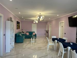 a living room with a couch and a table and chairs at Mare Azzurro in Marina di Camerota