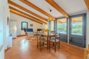 a dining room with a table and chairs at Mas Vinyoles 2 in Montnegre