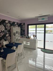a dining room with purple walls and tables and chairs at Mare Azzurro in Marina di Camerota +38 photos