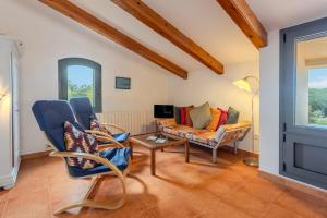 a living room with a couch and chairs and a table at Mas Vinyoles 2 in Montnegre