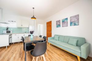 a living room with a couch and a table at Gran Sol Family 5 in Felanitx