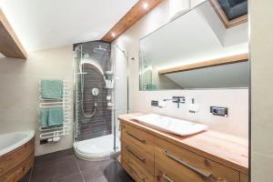 a bathroom with a sink and a shower at Apt Hetti - Haus Kostner in Santa Cristina Gherdëina +19 photos
